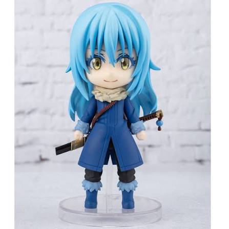 Anime character figurine with blue hair and a blue coat holding a sword on a white background