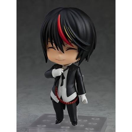 Small figurine with black hair and a suit on a gray background
